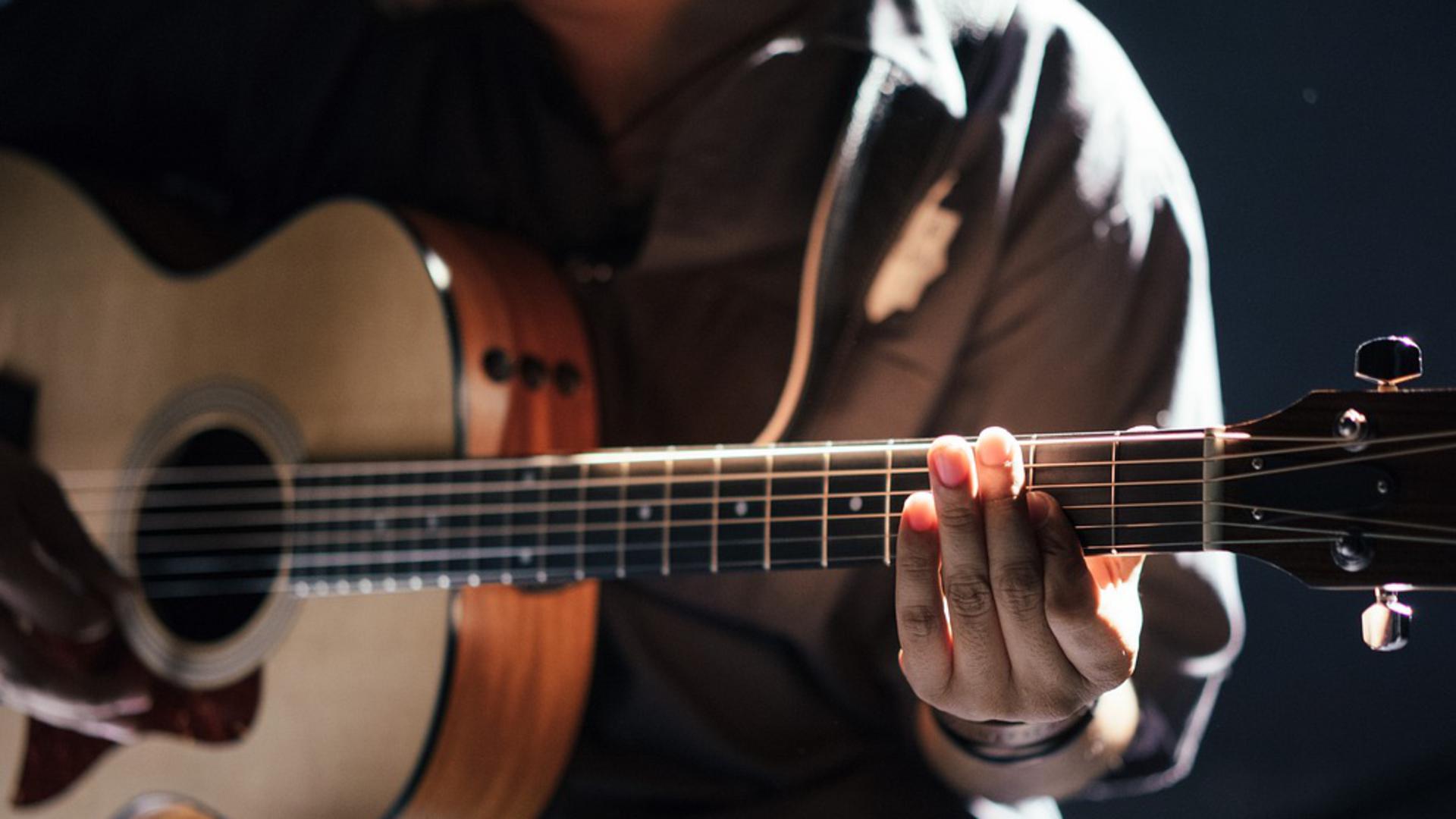 Person som spelar gitarr